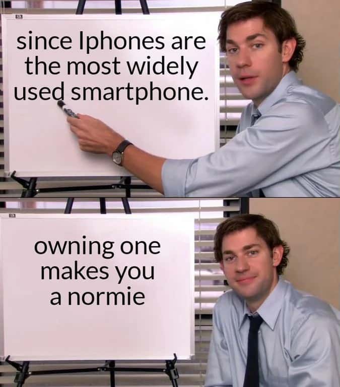 Jim halpert explains meme that owning iphone makes you a normie pointing at whiteboard