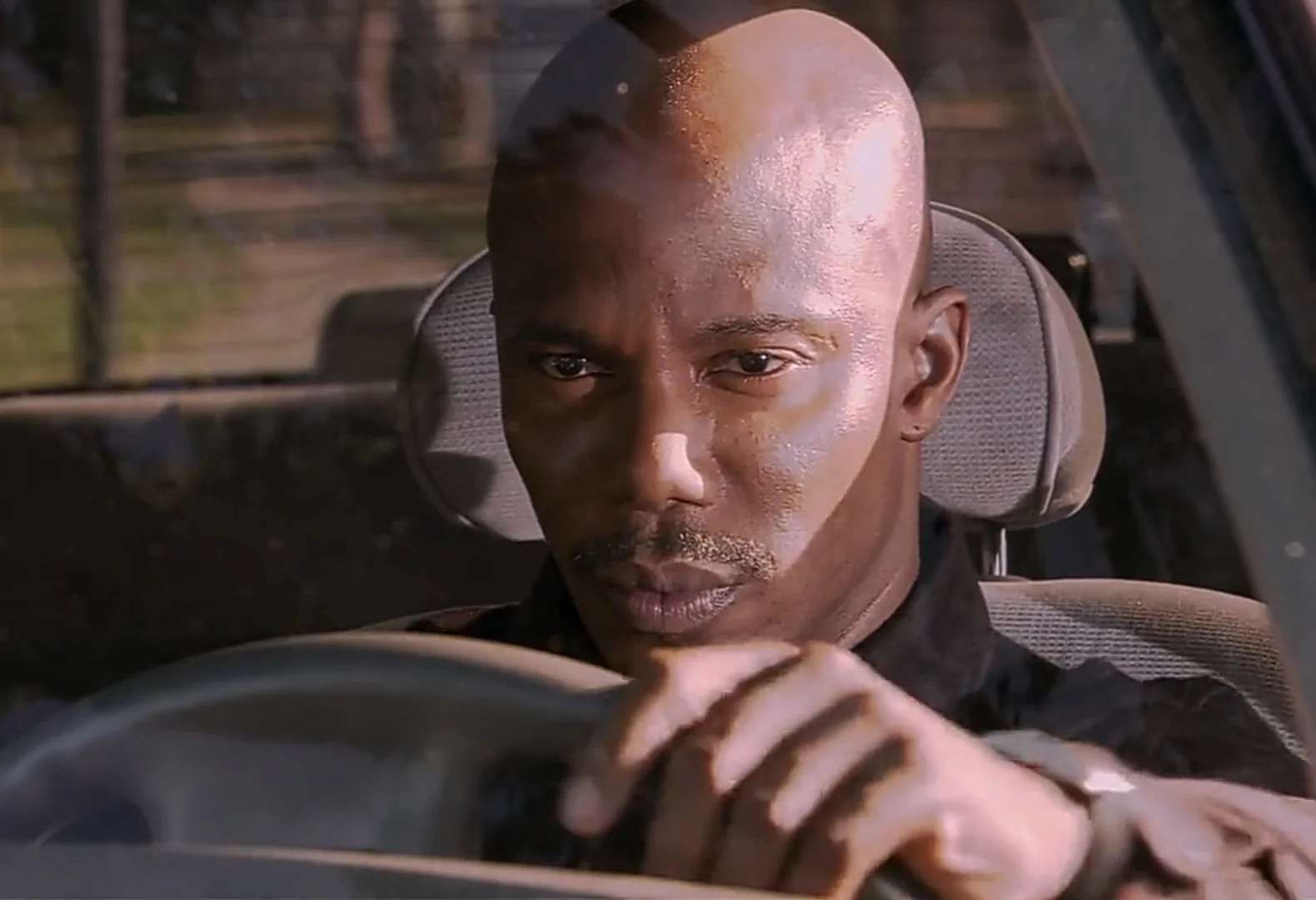 Doakes sus meme sitting in car staring at you with suspicious unblinking look