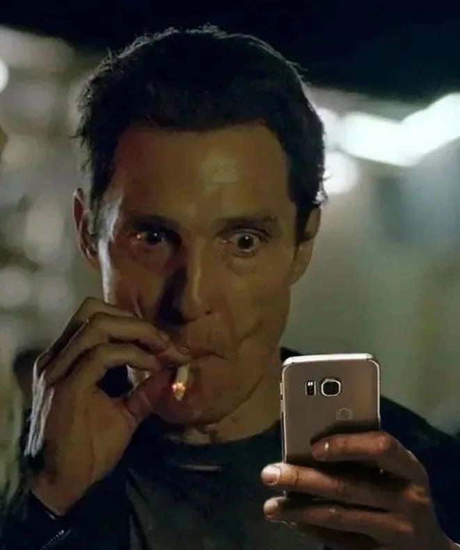 Matthew McConaughey smoking meme staring at phone shocked