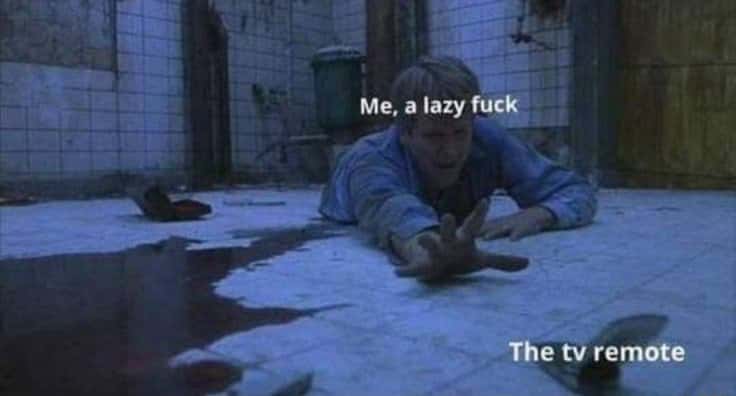 Lazy injured man meme crawling on floor straining to reach the tv remote