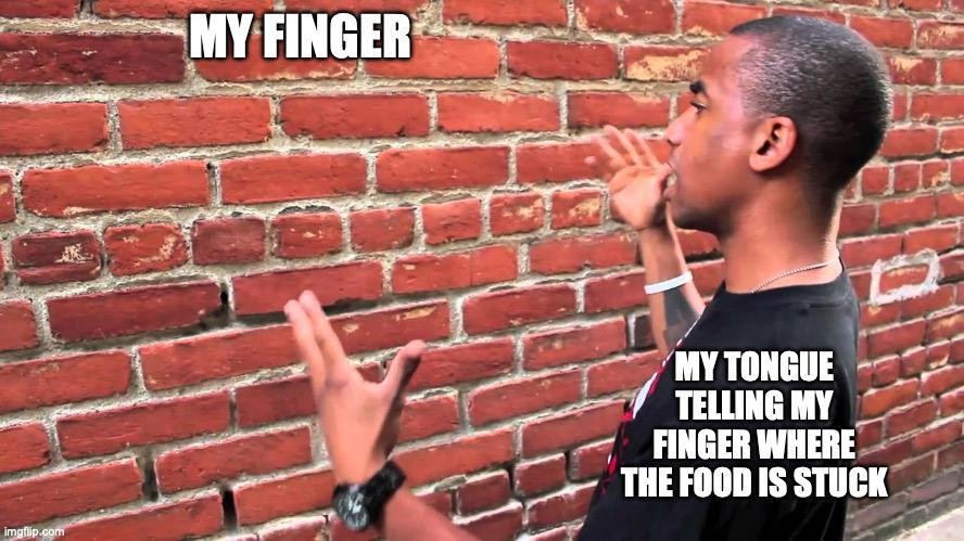 Talking to a brick wall: Relatable meme of tongue guiding finger to stuck food